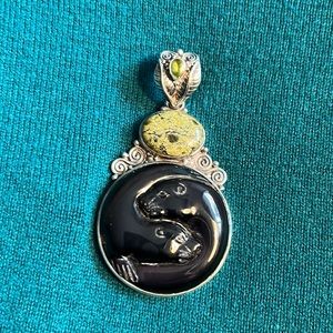 Silver pendant with two seals carved in black stone with carved silver bale